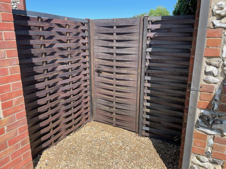 Wooden fence in sunny corner