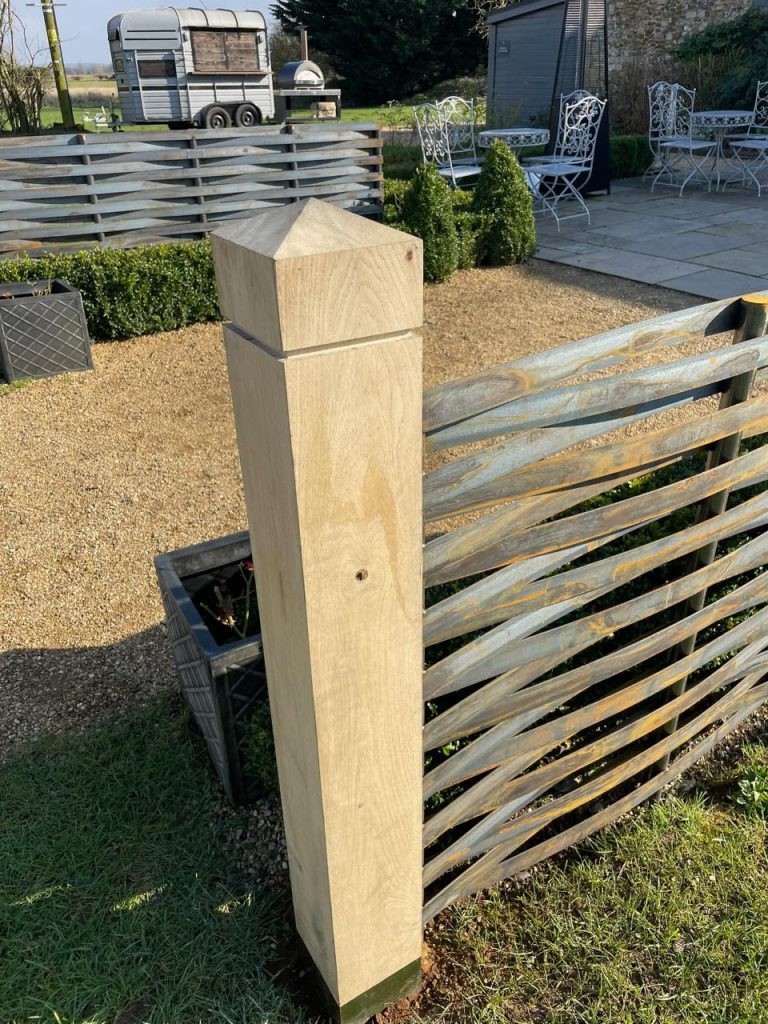 Wooden fence post in garden